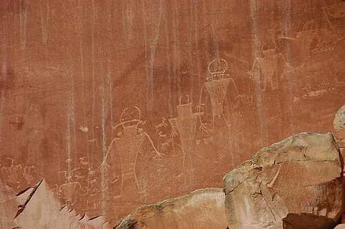 Fremont Culture petroglyph panel of bighorn sheep and trapezoidal human figures on a cliff along State Route 24 in Capitol Reef.