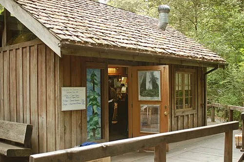 The Jedediah Smith visitor center, a shingled cedar cabin behind the redwood boardwalk where campers check in