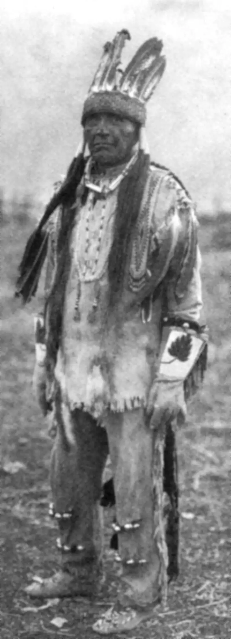A 1923 photograph of a Klamath man wearing traditional clothing.