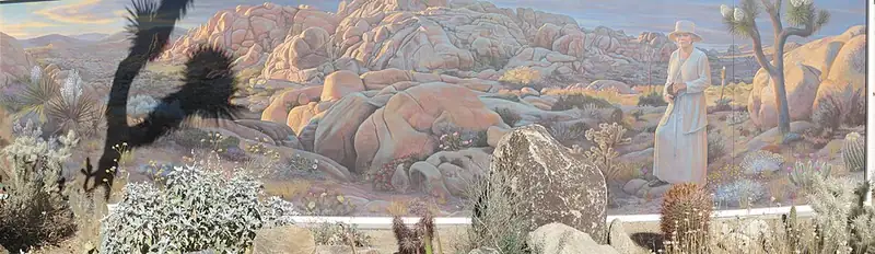 A painted mural of Minerva Hoyt at the Oasis Visitor Center, showing her face beside desert plants.