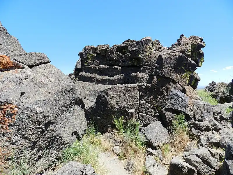 A rugged field of jagged black lava rock spreading out under an open sky, the Modoc homeland.