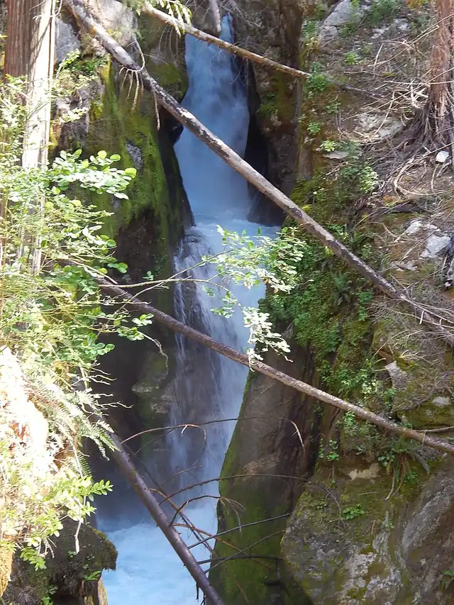 Ladder Creek Falls dropping through a narrow rock gorge behind the Gorge Powerhouse at Newhalem.