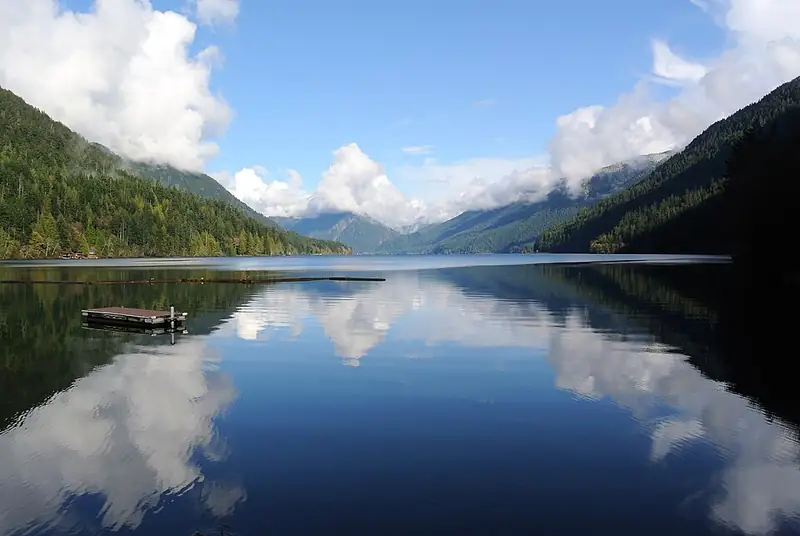 The clear, deep blue-green water of Lake Crescent below forested ridges.