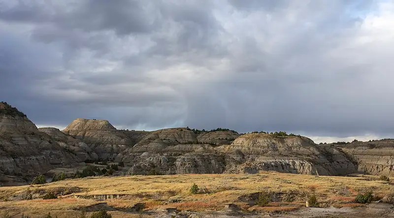 Layered red and tan badlands ridges in the North Unit of Theodore Roosevelt National Park.