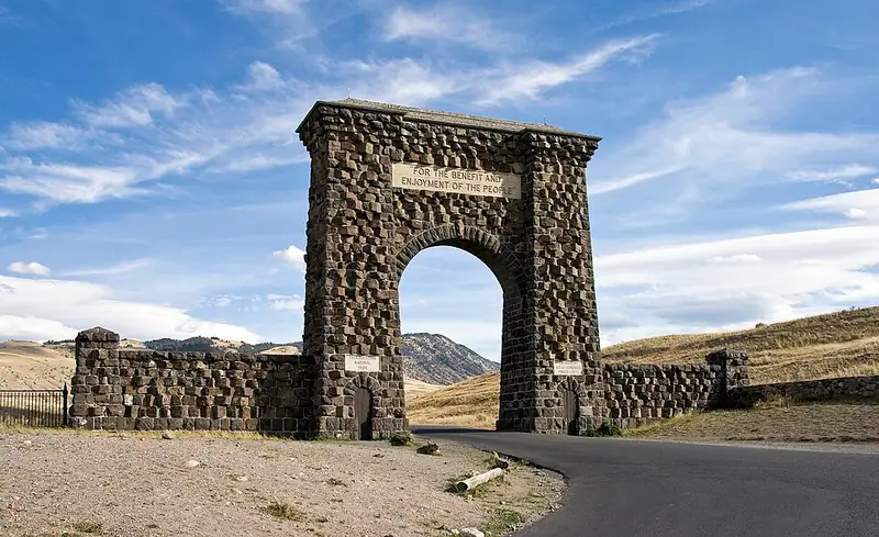 The stone Roosevelt Arch at the north entrance to Yellowstone, inscribed FOR THE BENEFIT AND ENJOYMENT OF THE PEOPLE.