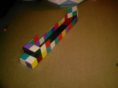 A boat built from translucent coloured magnetic tiles clicked together.